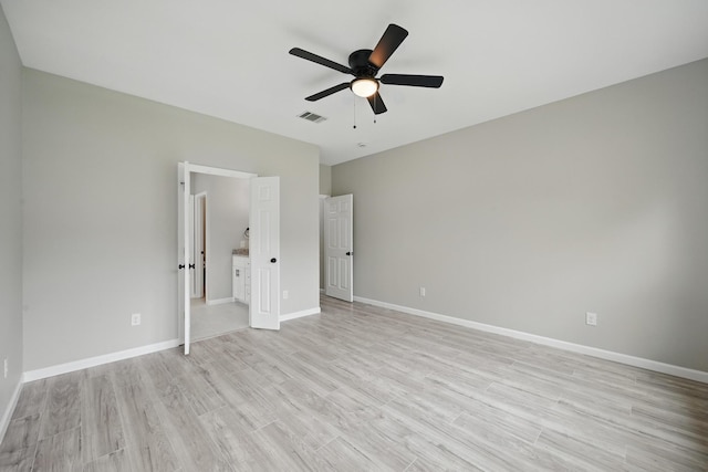 unfurnished bedroom featuring a ceiling fan, baseboards, visible vents, and light wood-style flooring
