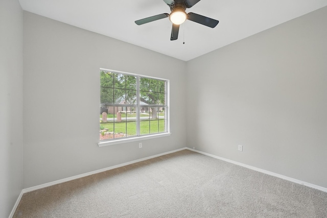 carpeted empty room with baseboards and ceiling fan