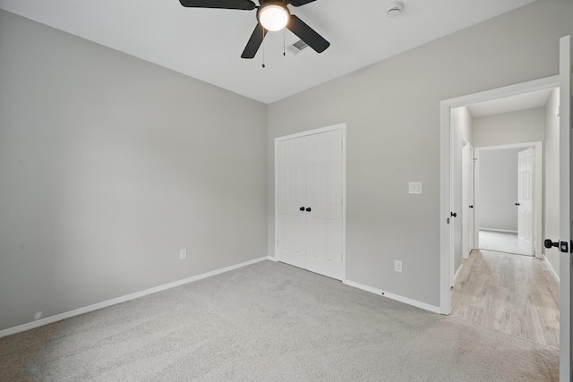 unfurnished bedroom featuring baseboards, visible vents, carpet, and a closet
