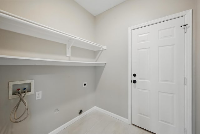 clothes washing area featuring washer hookup, hookup for an electric dryer, laundry area, hookup for a gas dryer, and baseboards