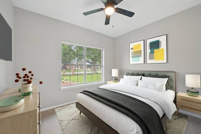 carpeted bedroom with baseboards and ceiling fan