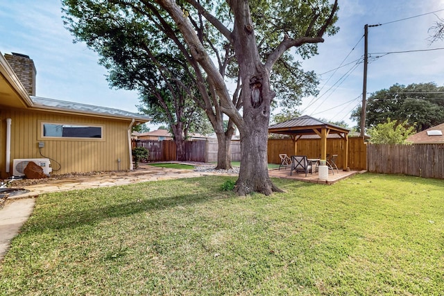 view of yard with a fenced backyard, a gazebo, cooling unit, and a patio area