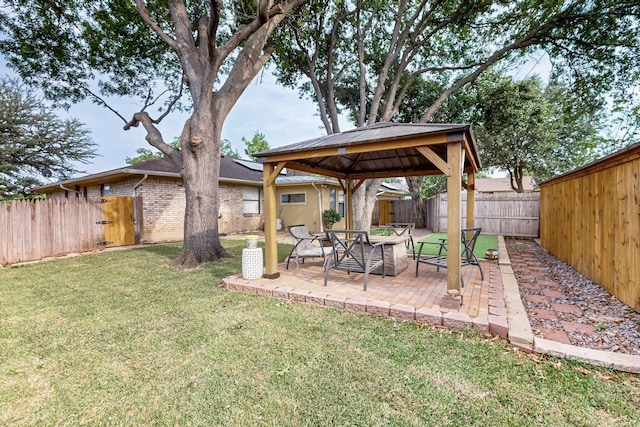 view of yard with a fenced backyard, a gazebo, and a patio area