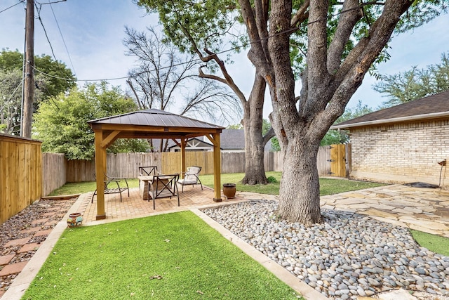 view of yard featuring a fenced backyard, a patio, and a gazebo