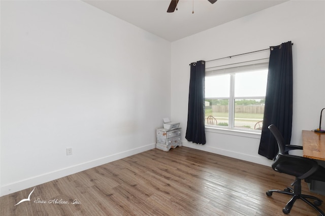 office with a ceiling fan, baseboards, and wood finished floors