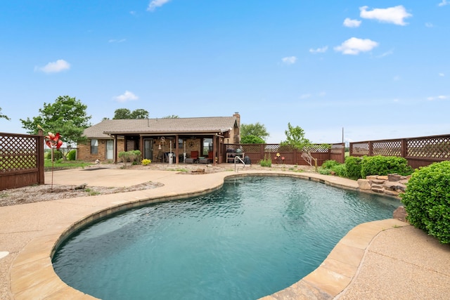 view of pool featuring a fenced in pool, a fenced backyard, and a patio area