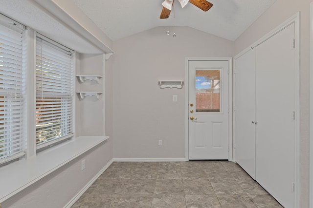 interior space featuring a ceiling fan and lofted ceiling