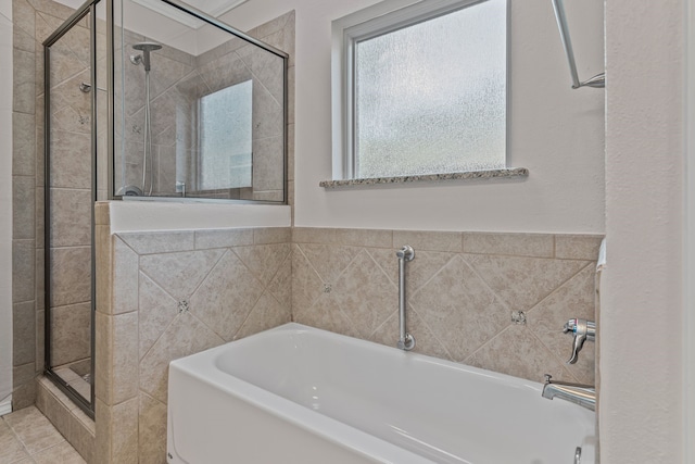 bathroom featuring a shower stall and a garden tub
