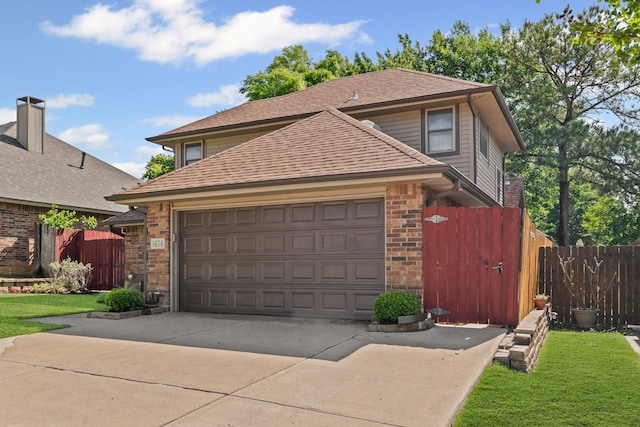 exterior space with fence, roof with shingles, brick siding, concrete driveway, and an attached garage