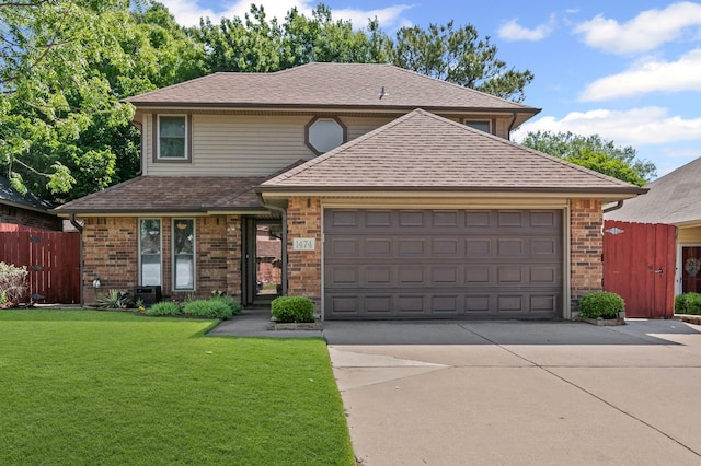 traditional-style house with driveway, a front yard, brick siding, fence, and an attached garage
