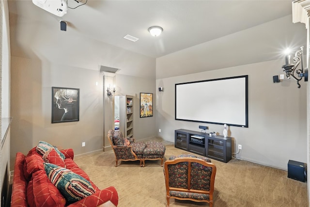 carpeted home theater room with baseboards, vaulted ceiling, and a notable chandelier