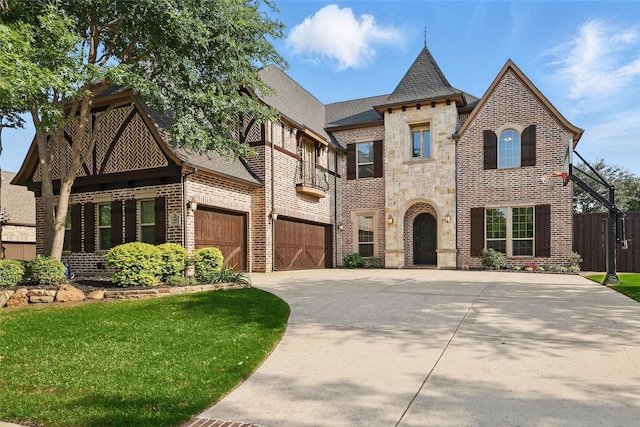 view of front facade with a front yard, stone siding, brick siding, concrete driveway, and an attached garage