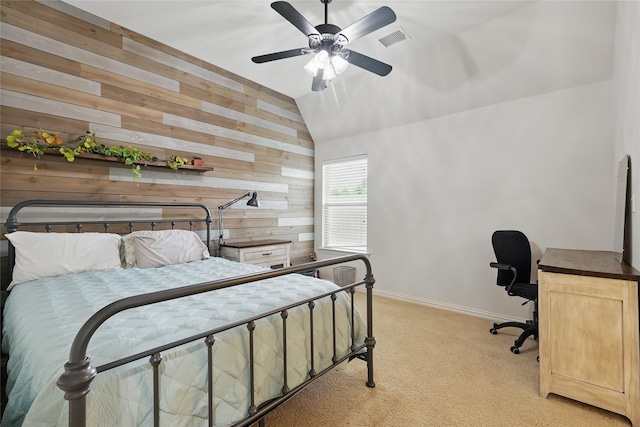 bedroom with visible vents, wood walls, baseboards, lofted ceiling, and light carpet
