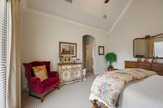 bedroom featuring crown molding, arched walkways, light carpet, and vaulted ceiling