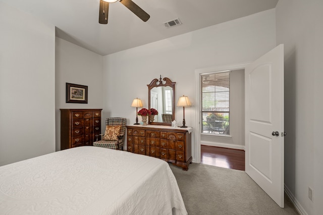carpeted bedroom featuring visible vents, a ceiling fan, and baseboards