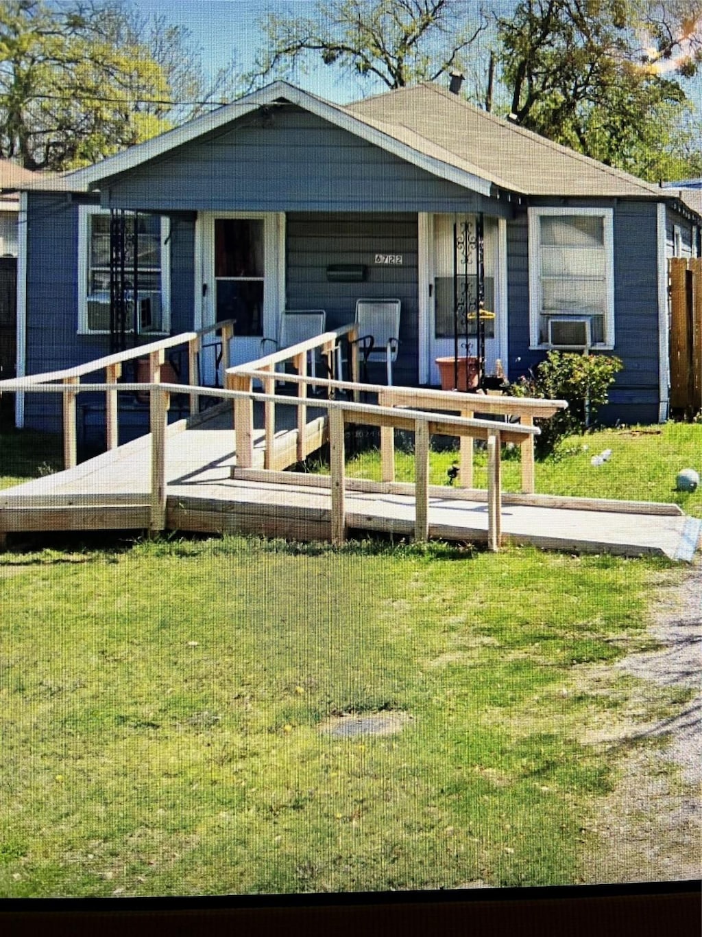 bungalow-style home with a front lawn
