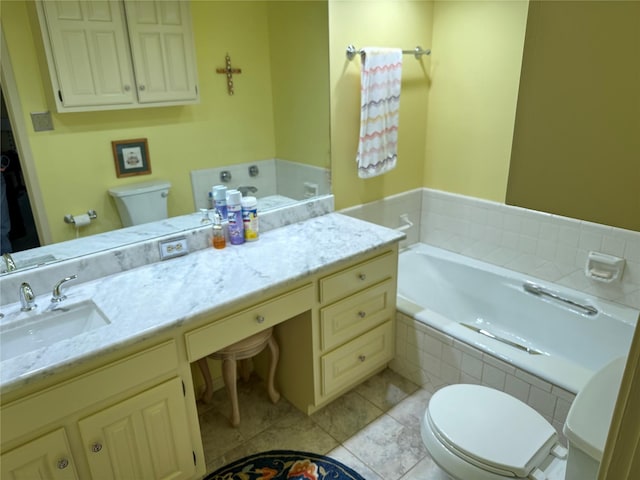 bathroom with vanity, tile patterned flooring, a bath, and toilet