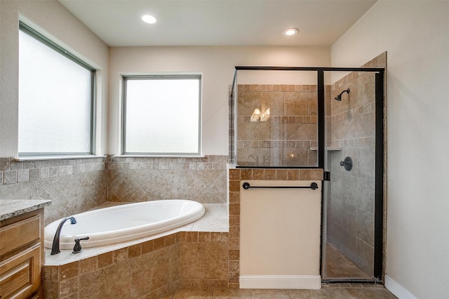 full bathroom with a garden tub, recessed lighting, vanity, and a shower stall