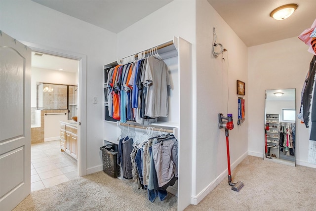 spacious closet featuring visible vents, light tile patterned floors, and light carpet