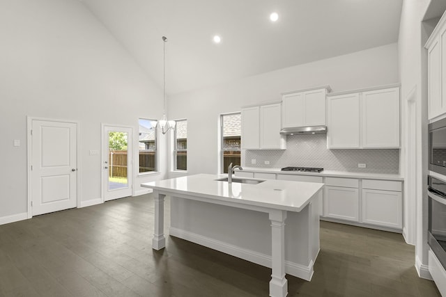 4327 Hudson St, Fate, TX 75087 - kitchen featuring a sink, stainless steel gas stovetop, high vaulted ceiling, light countertops, and decorative backsplash