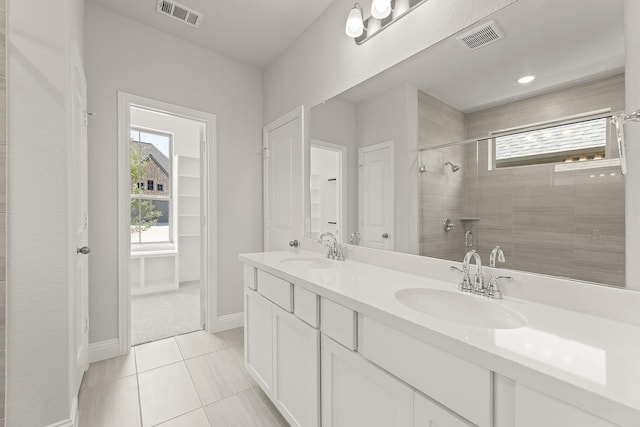 4327 Hudson St, Fate, TX 75087 - bathroom featuring plenty of natural light, a stall shower, tile patterned floors, and double vanity