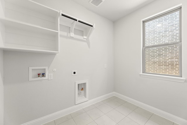 4327 Hudson St, Fate, TX 75087 - laundry room featuring gas dryer hookup, hookup for an electric dryer, baseboards, hookup for a washing machine, and light tile patterned floors