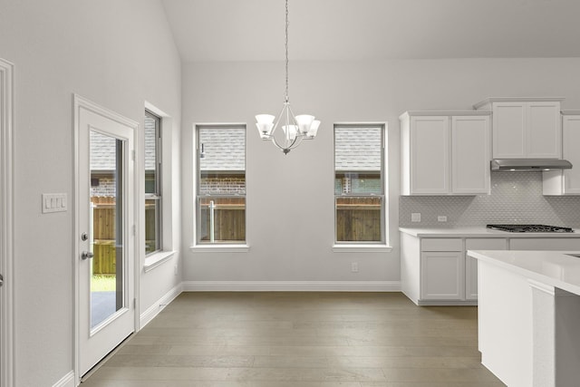4327 Hudson St, Fate, TX 75087 - kitchen featuring a chandelier, white cabinets, light countertops, plenty of natural light, and lofted ceiling