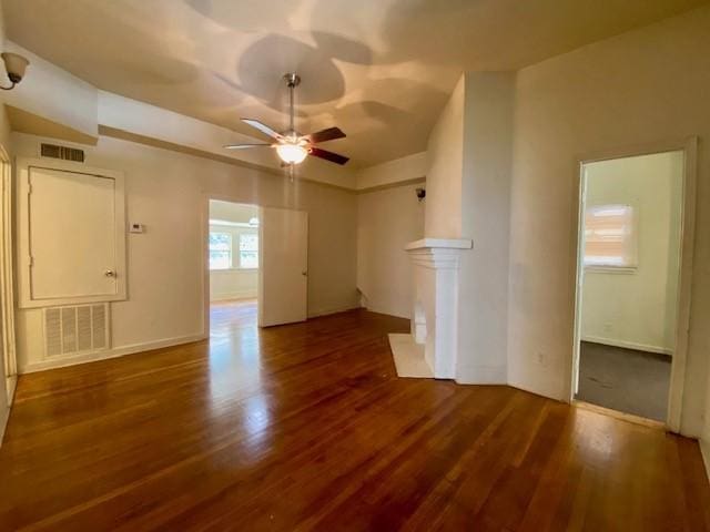 unfurnished room featuring visible vents, a ceiling fan, baseboards, and wood finished floors