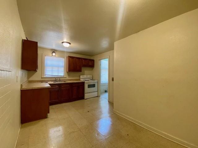 kitchen with light countertops, light floors, a sink, and white electric range
