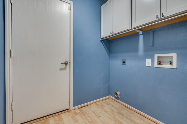 laundry area with electric dryer hookup, cabinet space, wood finished floors, baseboards, and hookup for a washing machine