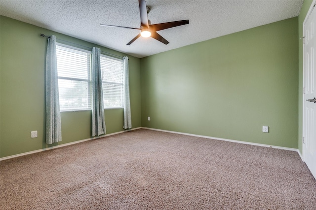 empty room featuring baseboards, ceiling fan, carpet flooring, and a textured ceiling
