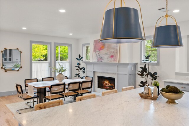 dining room featuring recessed lighting, visible vents, wood finished floors, and a fireplace