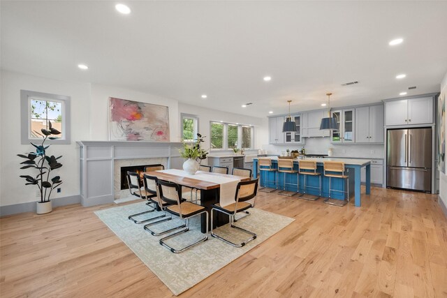 dining space with recessed lighting, light wood-style flooring, baseboards, and visible vents