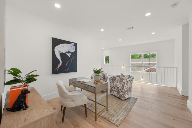 living area with recessed lighting, visible vents, and light wood finished floors