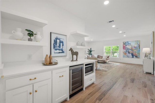 4401 El Campo Ave, Fort Worth, TX 76107 - bar area featuring beverage cooler, stainless steel microwave, light wood-type flooring, and recessed lighting