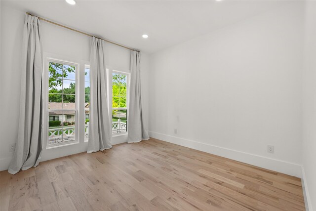 unfurnished room with baseboards, recessed lighting, and wood finished floors