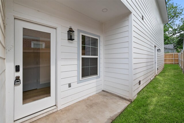 view of front of property with french doors, a front lawn, and a balcony