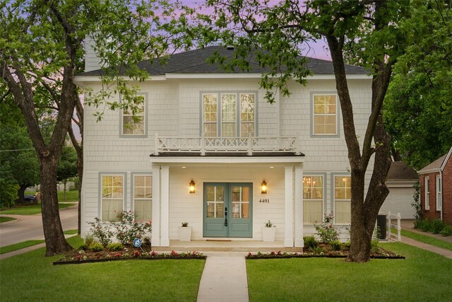 view of front of property with central air condition unit, french doors, and a front yard