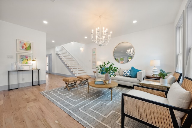 living area with recessed lighting, a chandelier, stairway, and light wood-style floors