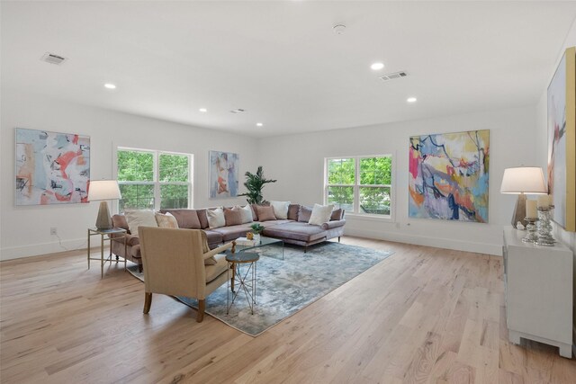 dining room featuring recessed lighting, visible vents, wood finished floors, and a high end fireplace