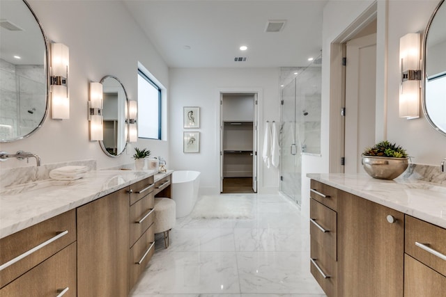 full bath with visible vents, marble finish floor, a stall shower, and a soaking tub