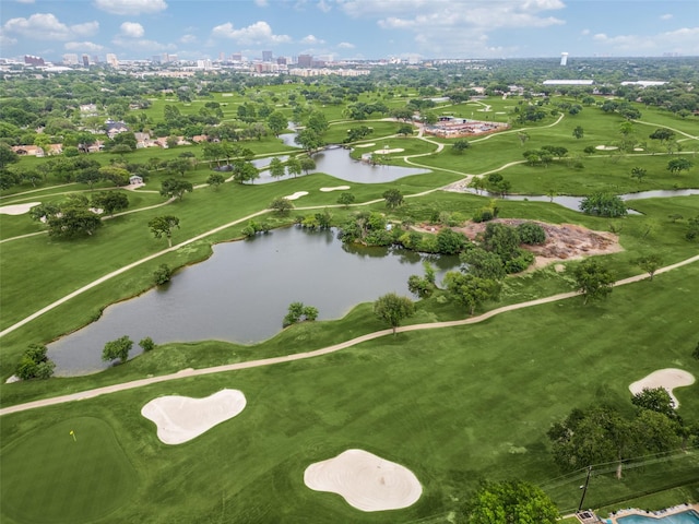 drone / aerial view featuring a water view, view of golf course, and a view of city