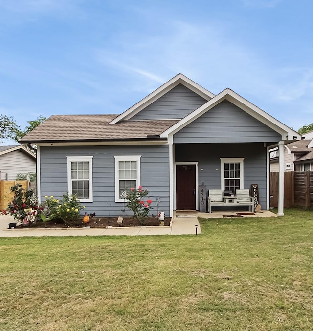 4713 Garrison Ave, Dallas, TX 75216 - view of front of property with a porch, a shingled roof, fence, and a front yard