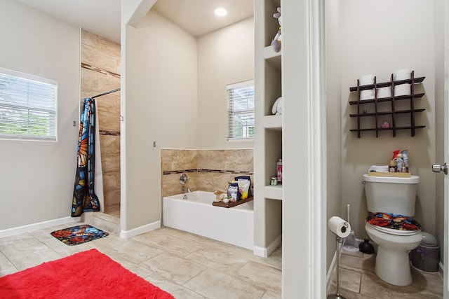 4713 Garrison Ave, Dallas, TX 75216 - full bathroom featuring baseboards, a shower stall, a garden tub, and toilet
