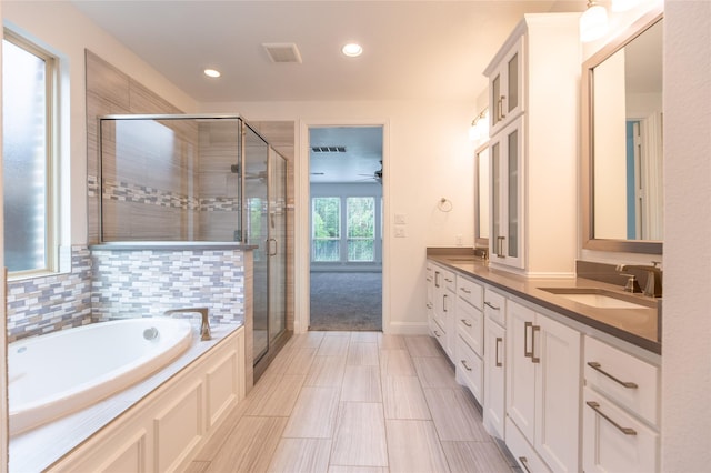 5521 Riverside Ln, Mckinney, TX 75070 - full bath with a sink, double vanity, recessed lighting, a shower stall, and a garden tub