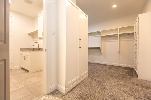 5521 Riverside Ln, Mckinney, TX 75070 - spacious closet with light colored carpet, a sink, and visible vents