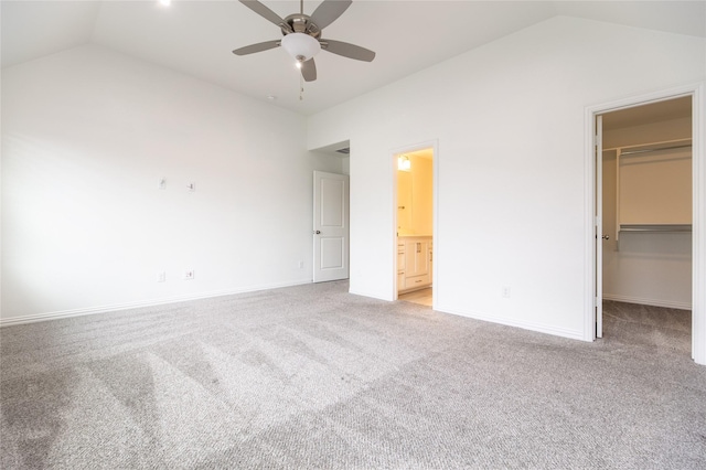 5521 Riverside Ln, Mckinney, TX 75070 - unfurnished bedroom with a walk in closet, baseboards, light colored carpet, and lofted ceiling
