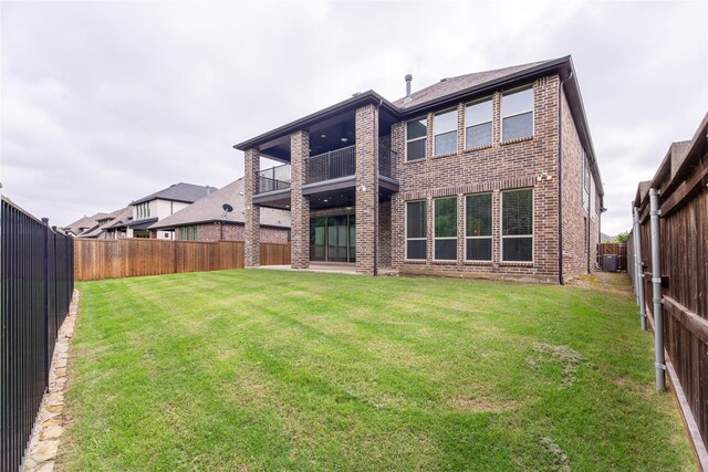 5521 Riverside Ln, Mckinney, TX 75070 - rear view of property with a lawn, brick siding, a balcony, and a fenced backyard