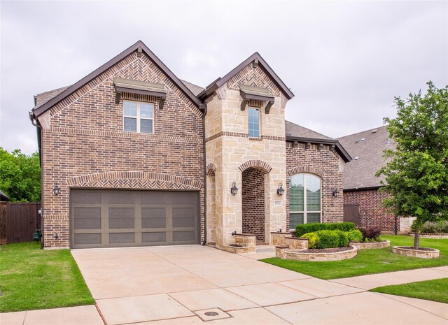 5521 Riverside Ln, Mckinney, TX 75070 - french country inspired facade featuring an attached garage, a front lawn, stone siding, brick siding, and driveway