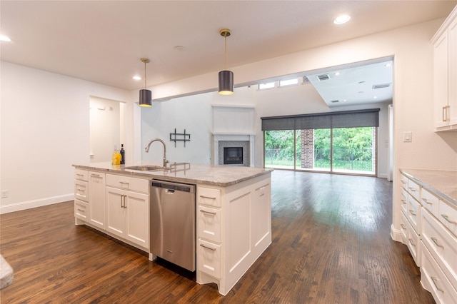 5521 Riverside Ln, Mckinney, TX 75070 - kitchen with stainless steel dishwasher, a sink, dark wood-style floors, and open floor plan